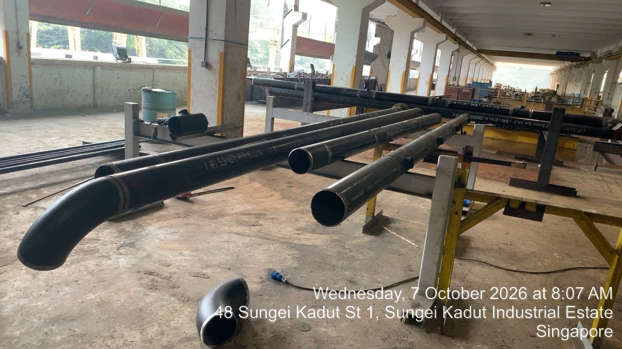 Fabricated carbon steel piping spools placed on workshop support trestles