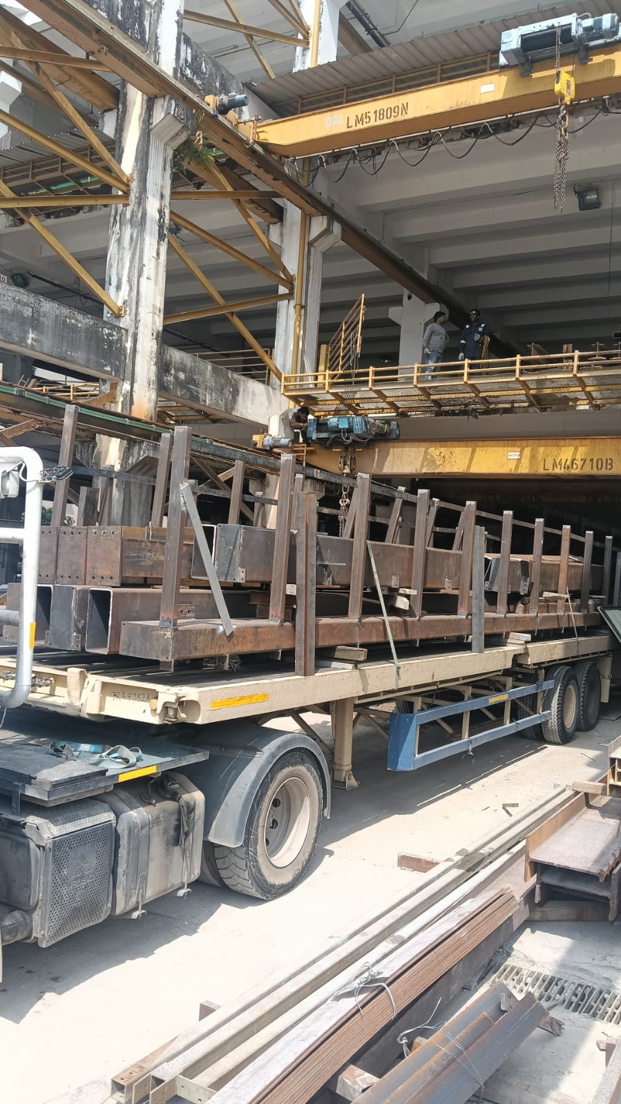 Rigged prefabricated steel structures on flatbed transport
