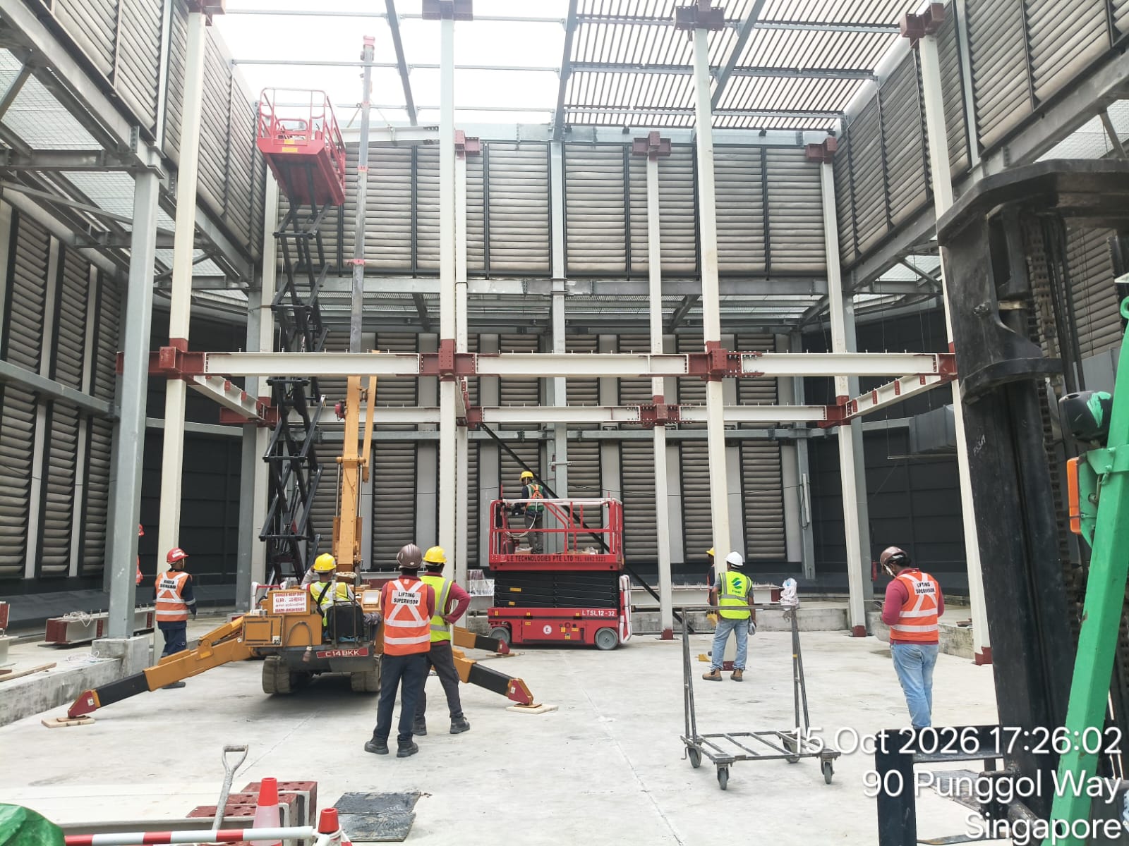 Rigger securing structural connections and tension bolts on high-bay framing